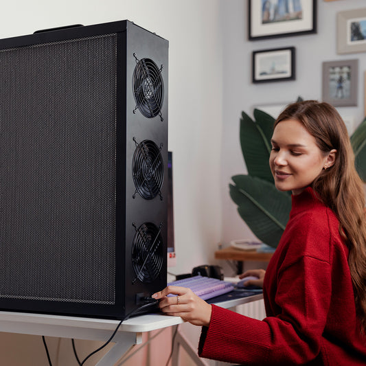 Woman in a red sweater adjusting the speed on her Tempest Pro air purifier.